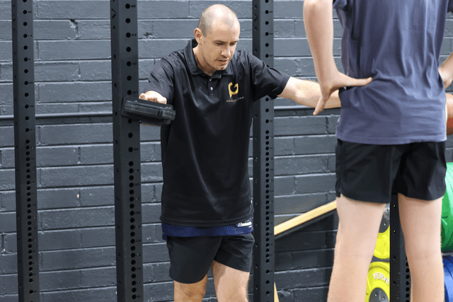 Exercise scientist, Jarryd Cursio, monitoring an athlete during training at Project Gap.